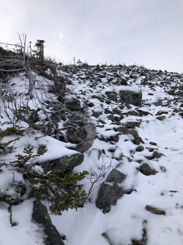 The snow covered talus slope trail leading to the summit of Mt Abraham in Strong Maine