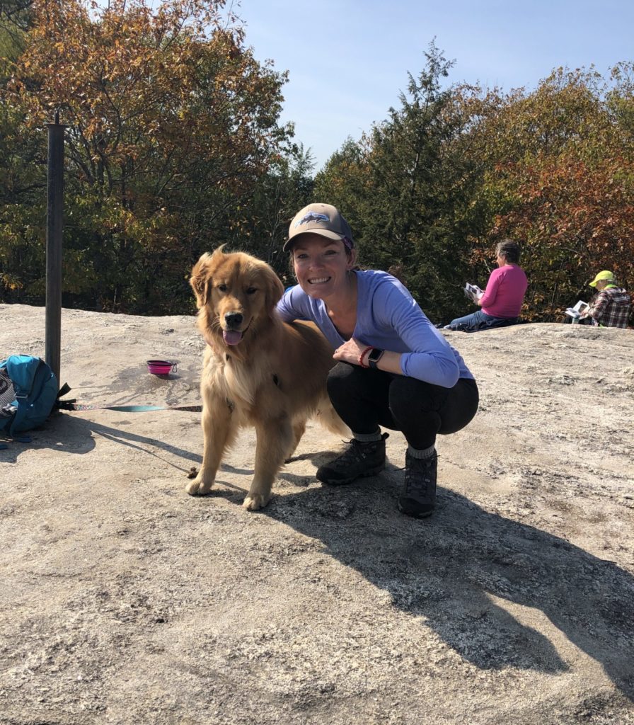 A hiker and a dog seen while hiking Bradbury Mountain in Bradbury Mountain State Park, Freeport, Maine