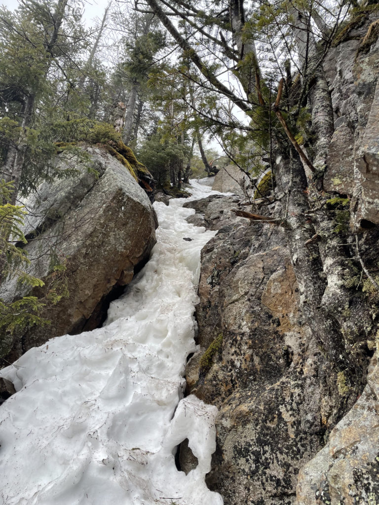 A rock chimney and ice floe, seen while hiking East Osceola in the White Mountains, New Hampshire