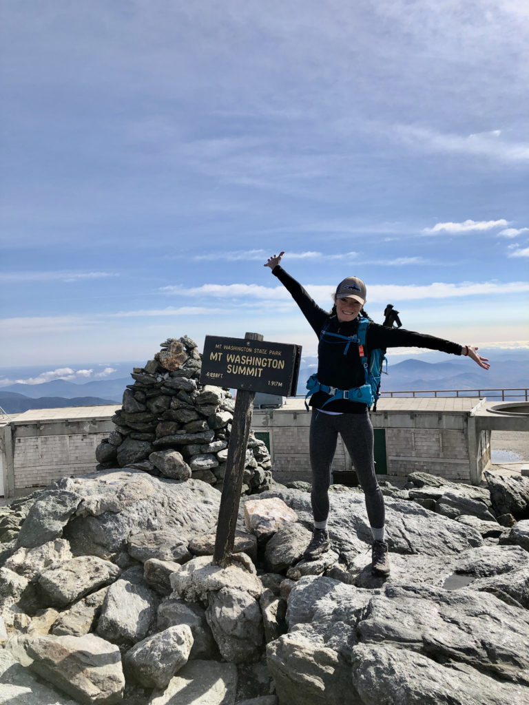 A person at the summit of Mt Washington, New Hampshire