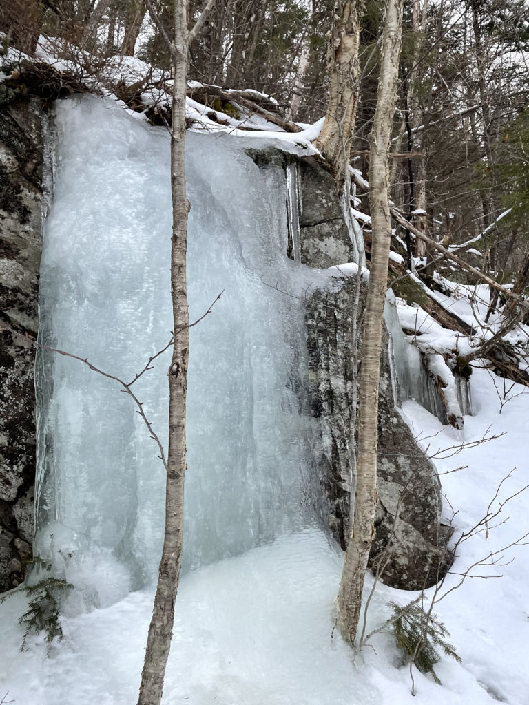 A sheet of ice over a boulder, seen while hiking Mt. Isolation in the White Mountains, New Hampshire