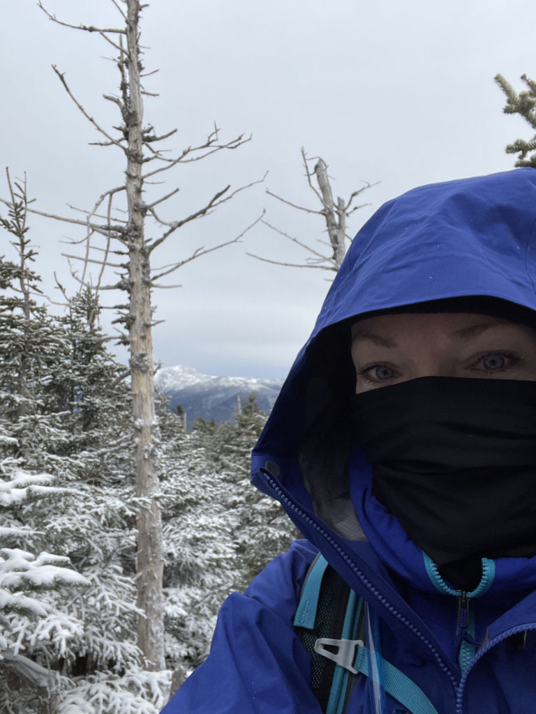 A person in winter gear, hiking Mt. Tom, Mt. Willey, and Mt. Field in the White Mountains, New Hampshire