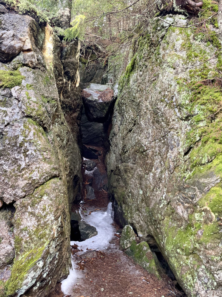 A rock suspended between two boulders, seen while hiking Wildcat Mtn in the White Mountains, New Hampshire