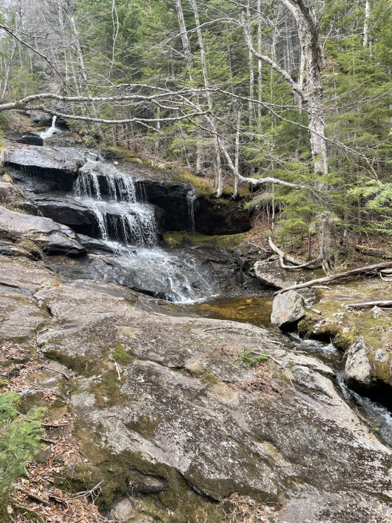 A forest waterfall, seen while hiking and backpacking the Grafton Notch Loop Trail in the White Mountains, Maine