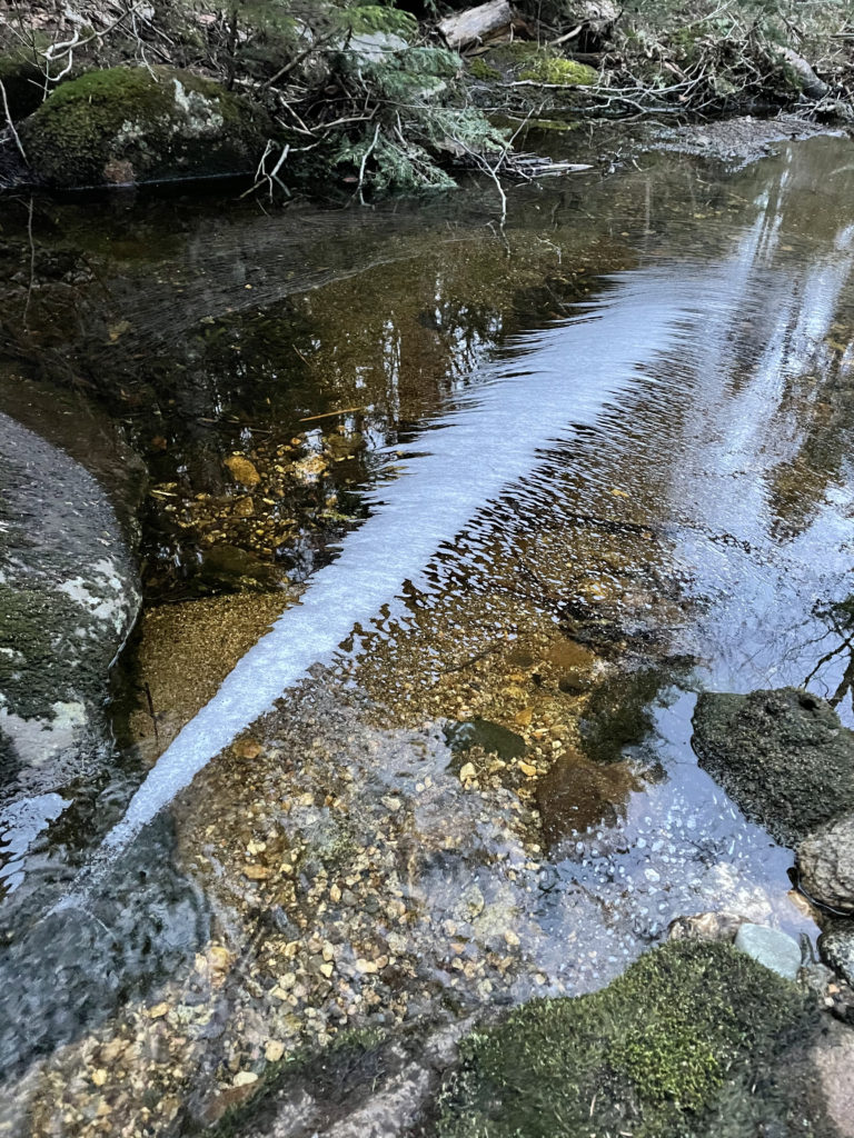 Bubbles in a cascade, seen while hiking and backpacking the Grafton Notch Loop Trail in the White Mountains, Maine