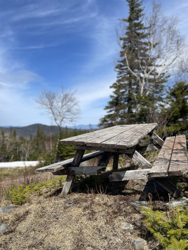 An old picnic table, seen while hiking Sugarloaf and Spaulding Mountains in Western Maine