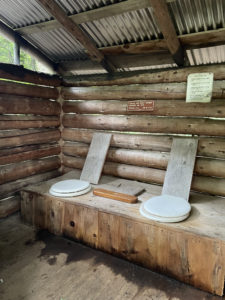 Inside a double outhouse with a cribbage board, seen while hiking Saddleback and The Horn, Western Mountains, Maine