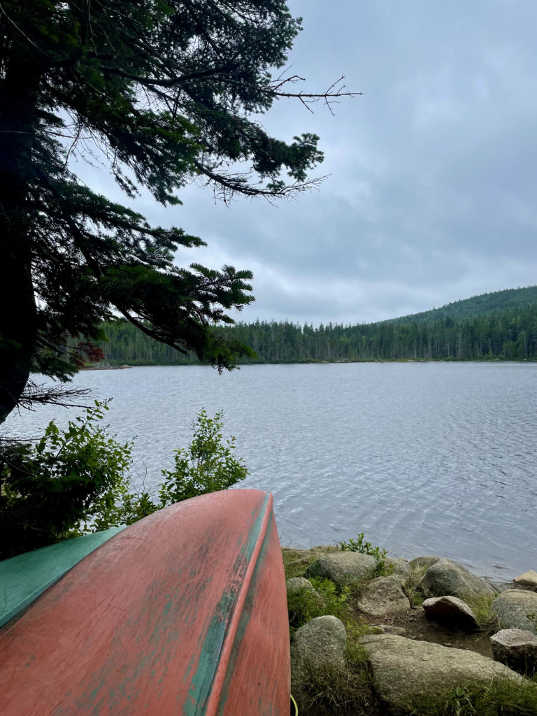 Canoes by a lake, seen while hiking Saddleback and The Horn, Western Mountains, Maine
