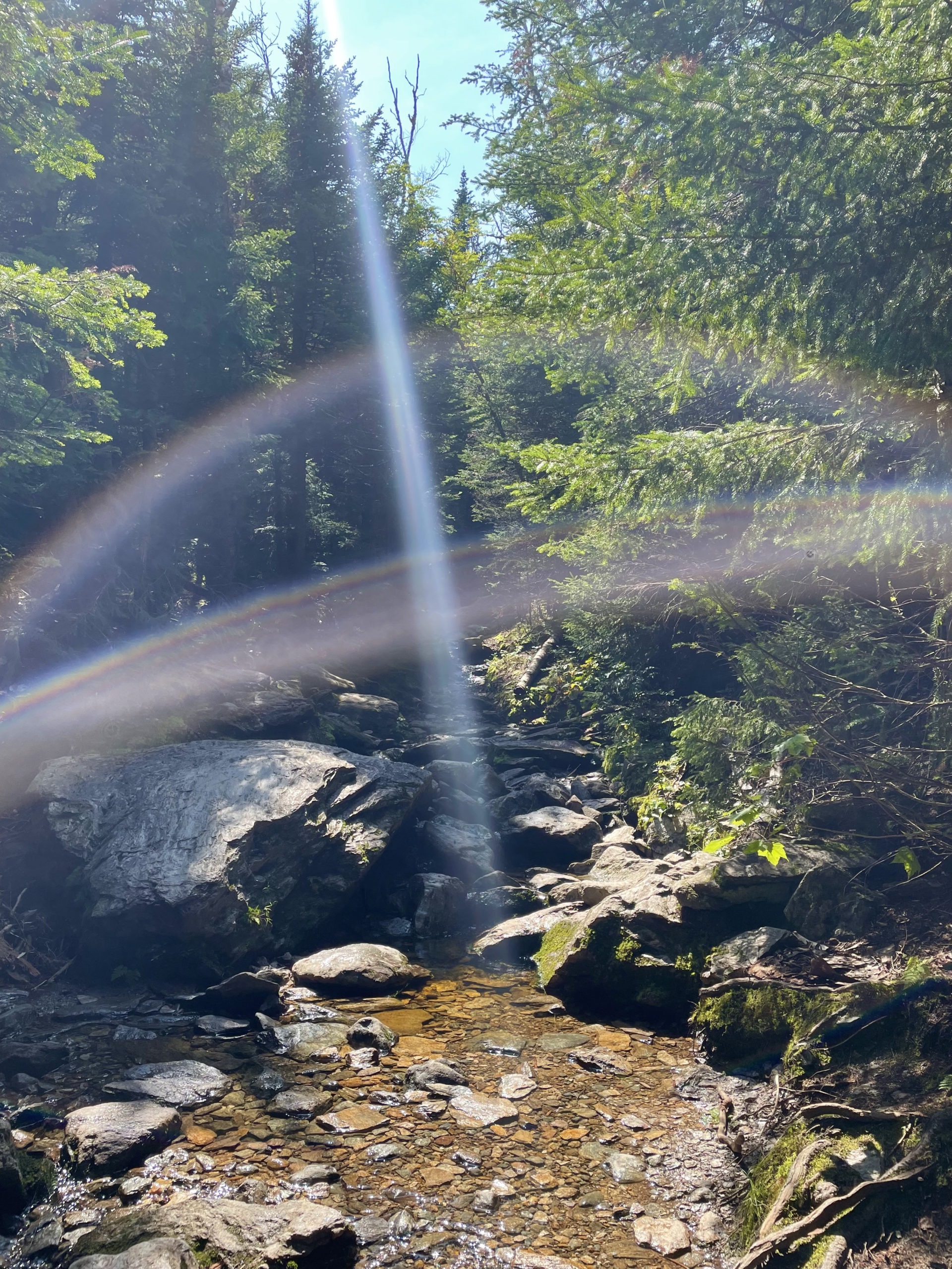 Rainbow over a cascade, seen while hiking Camel's Hump in the Green Mountains, Vermont