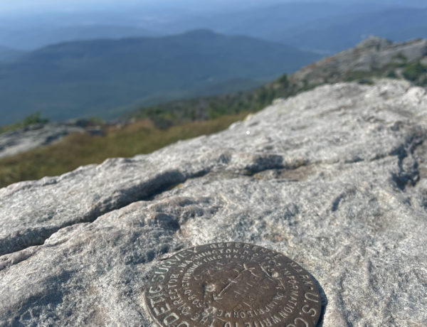 Summit geological marker, seen while hiking Camel's Hump in the Green Mountains, Vermont