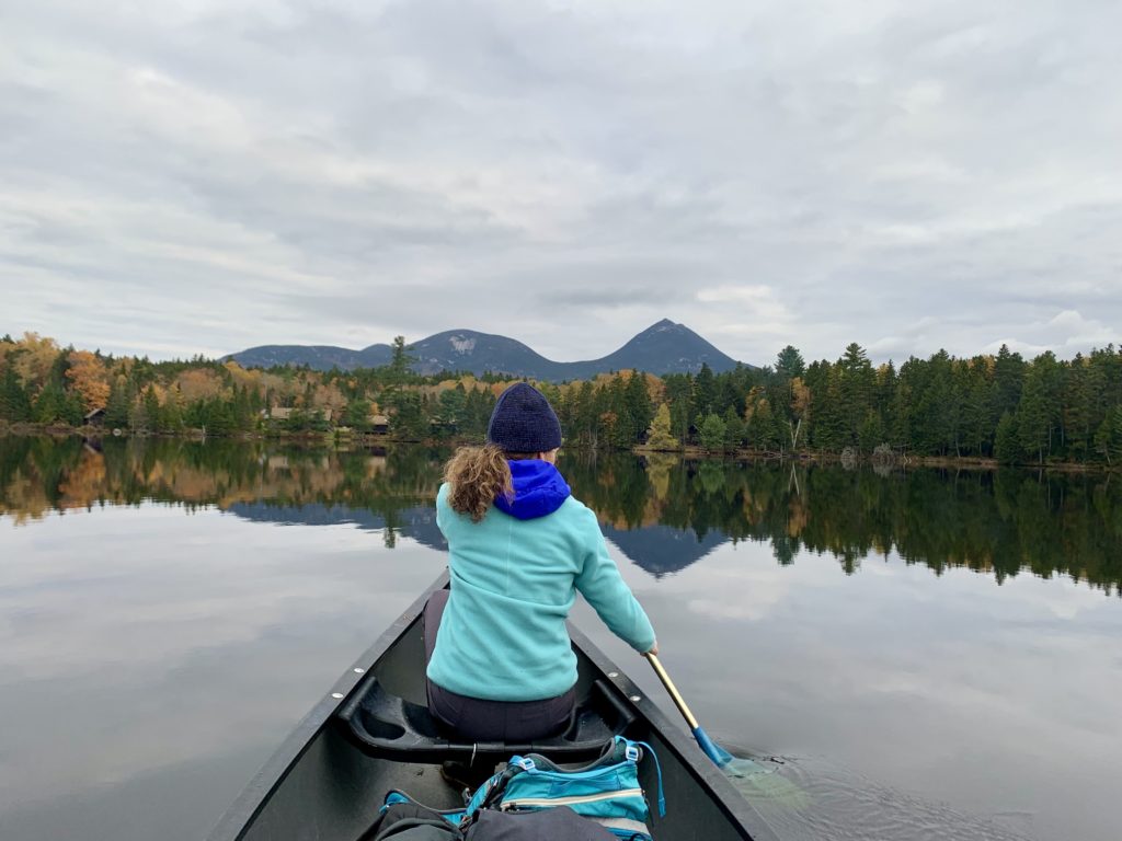 Canoeing across Kidney Pond in Baxter State Park, Maine, with Doubletop Mountain in the distance