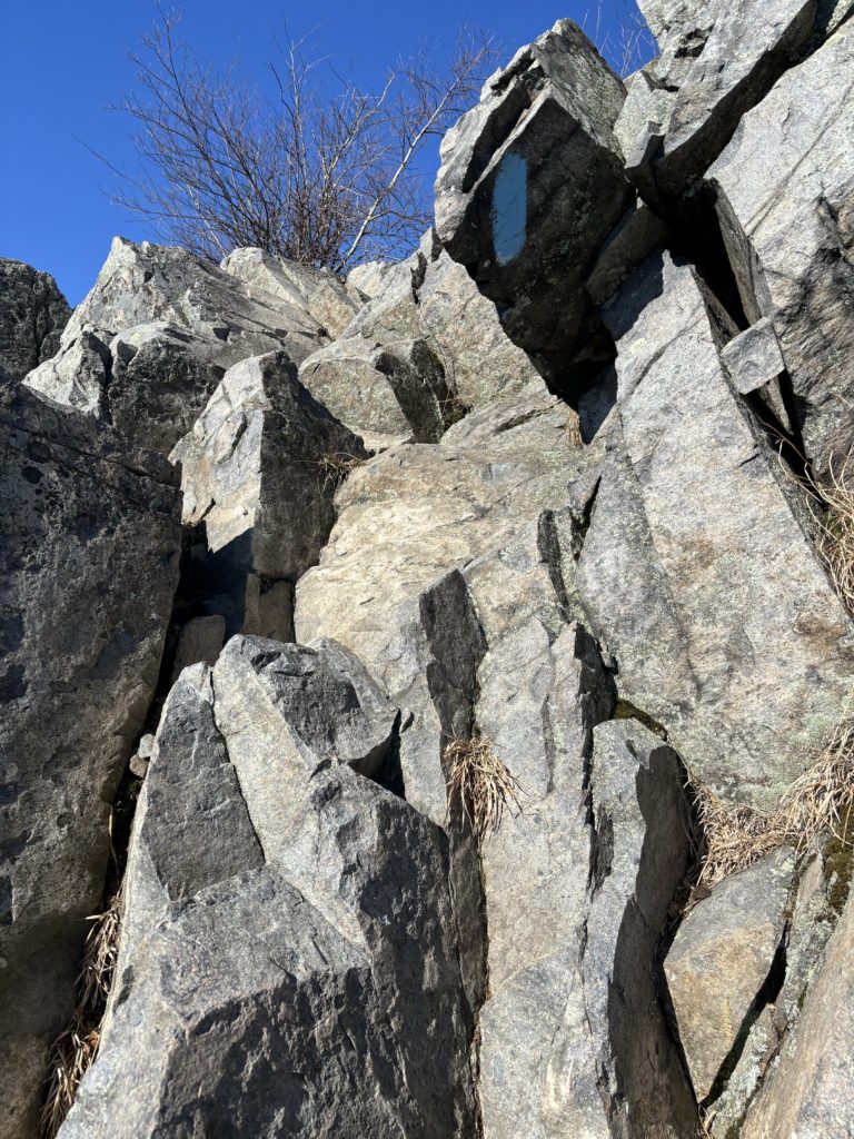 Climbing the rocks while hiking at Burnt Meadow Mountain, Maine