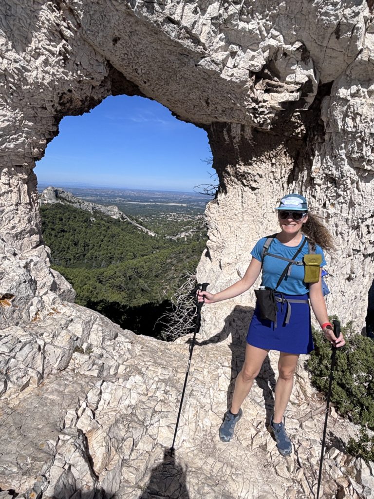 Standing in front of rocker des 2 trous, Les Alpilles and Mount Ventoux from a trail in Saint Remi, Provence, France